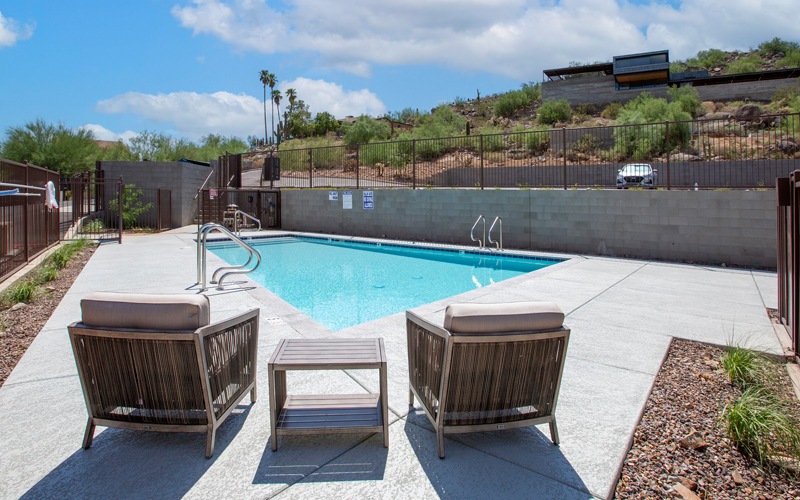 Resort-style swimming pool with lounge seating